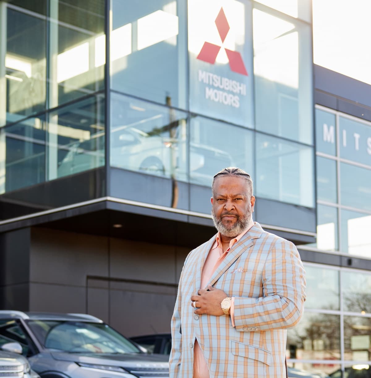 Marcus Withers standing in front of a dealership